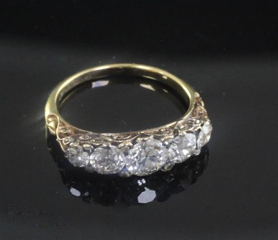 An early 20th century 18ct gold and graduated five stone diamond half hoop ring, size L.